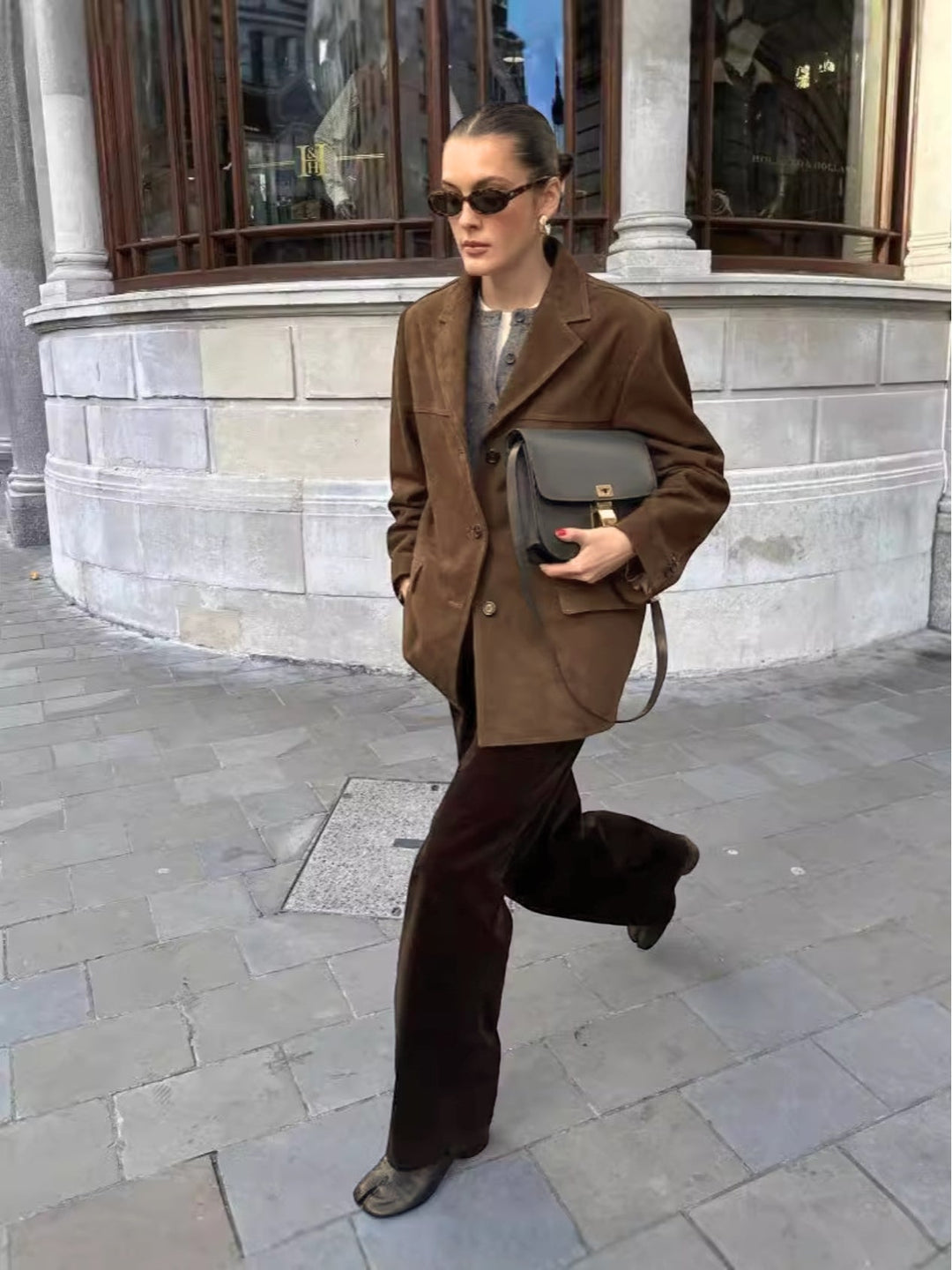 Effortless style: women's oversized suede jacket featuring a button-front design, ideal for a chic, casual look.