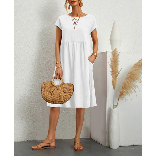 A woman posing in a relaxed fit summer midi dress, suitable for beach days or everyday errands.