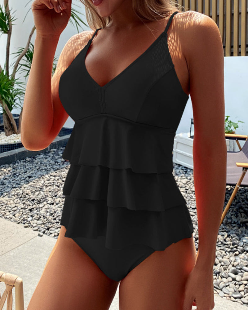 Comfortable women's ruffle tankini swimsuit with adjustable straps. High-rise bottom, perfect for summer pool days.