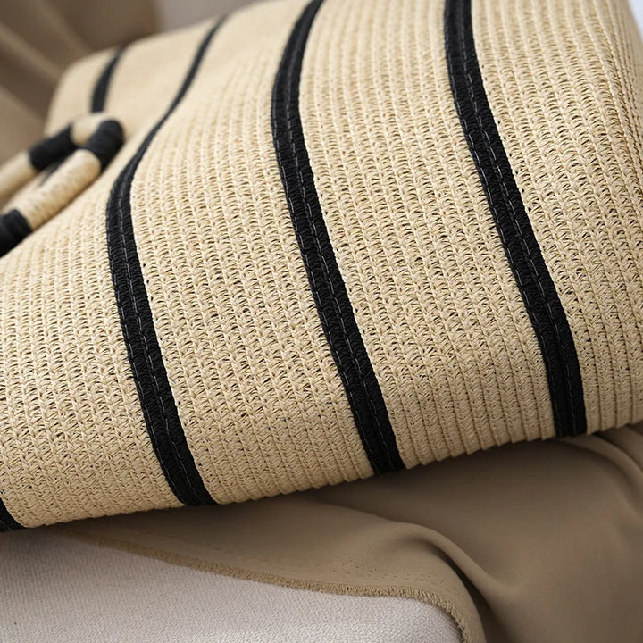 Fashionable striped tote bag for women, featuring unique woven handles. Great for summer style & beach days.