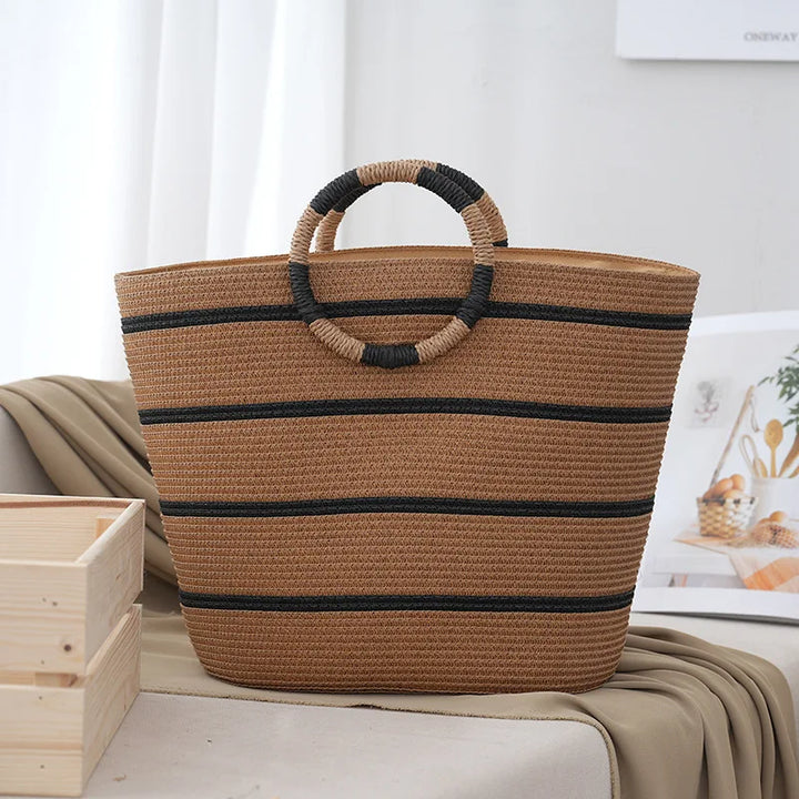 Chic striped women's tote bag with sturdy woven handles, a versatile everyday fashion accessory for summer.