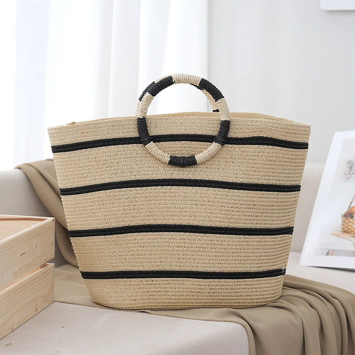 Women's striped tote bag with woven handles, perfect for summer style & beach. A fashionable everyday carryall.