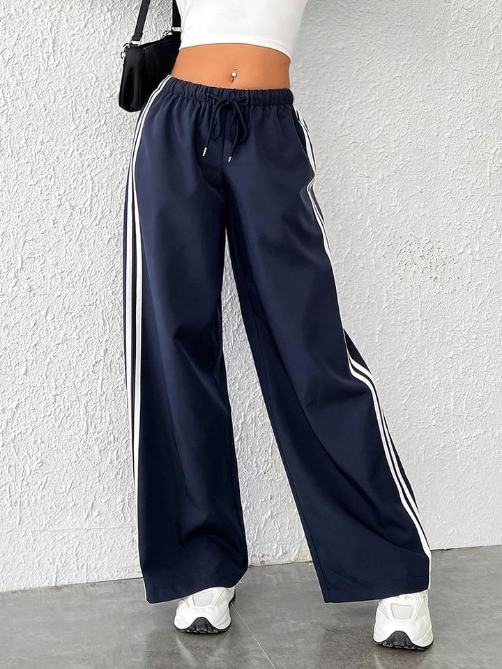 Stylish women's palazzo trackpants featuring a chic side stripe. Perfect for casual comfort & modern fashion.