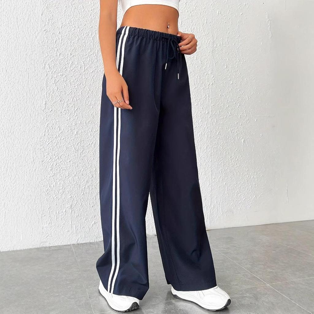 Comfortable women's wide leg trackpants with a drawstring waist and trendy side stripe. Versatile athleisure wear.