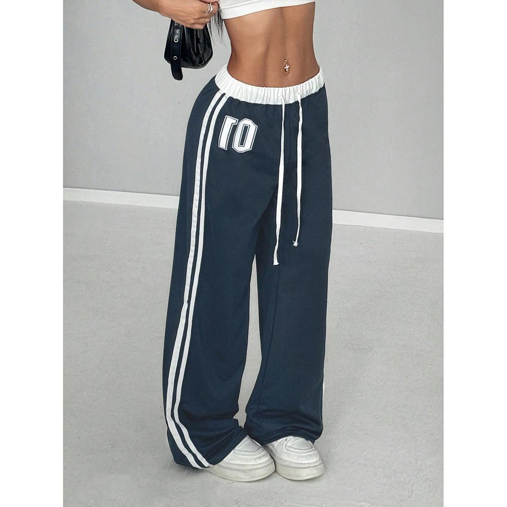 Comfortable women's baggy wide leg trackpants, featuring stylish stripes and a practical adjustable drawstring closure.