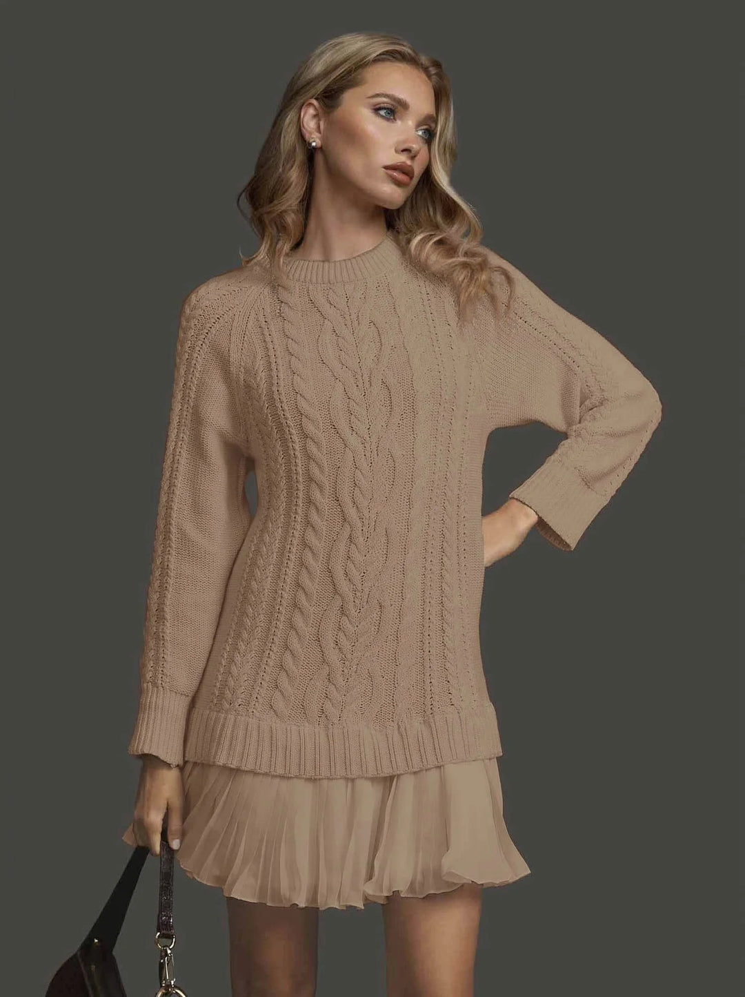 Stylish women's cable knit winter dress with cozy long sleeves and a sophisticated pleated hem.