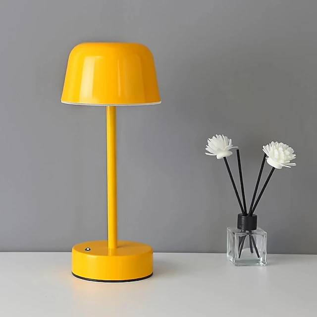 Elegant cordless table lamp, metal construction, dimmable flare design for sophisticated decor.