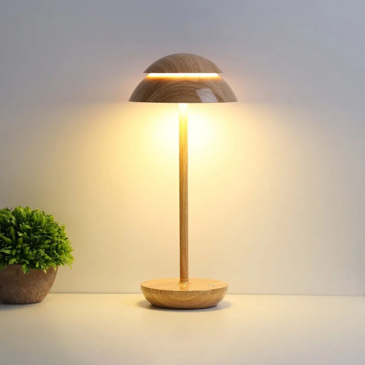 Top view of modern Nordic LED table lamp, minimalist design & soft light diffusion. Dimmable & rechargeable.