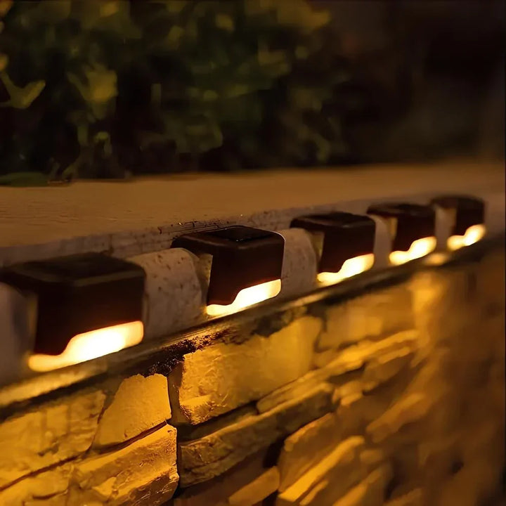 Close-up of a Nvroome solar step light's integrated solar panel and warm glow LED.