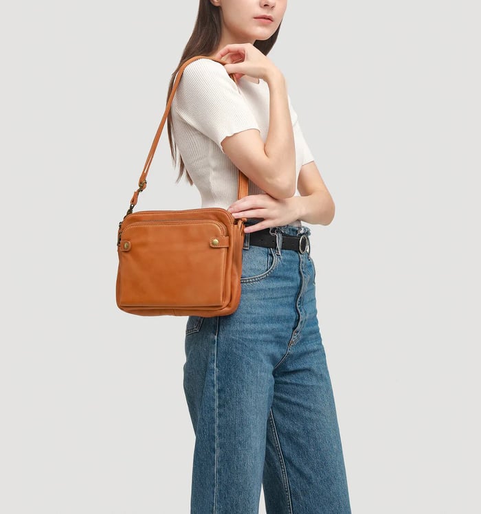 Women's premium full-grain leather crossbody bag with integrated wallet features.