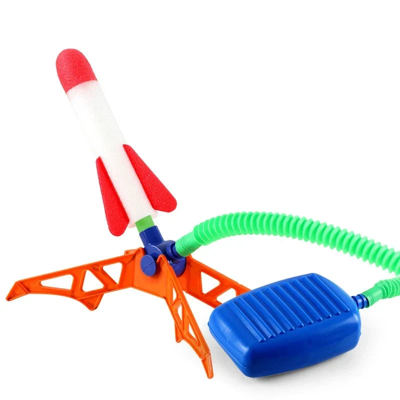 Children launching air powered rockets outdoors with a foot pedal; an exciting no-battery play toy.