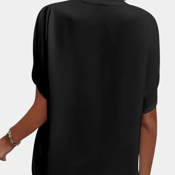 Airy short-sleeve summer blouse for women, loose fit & casual wear.