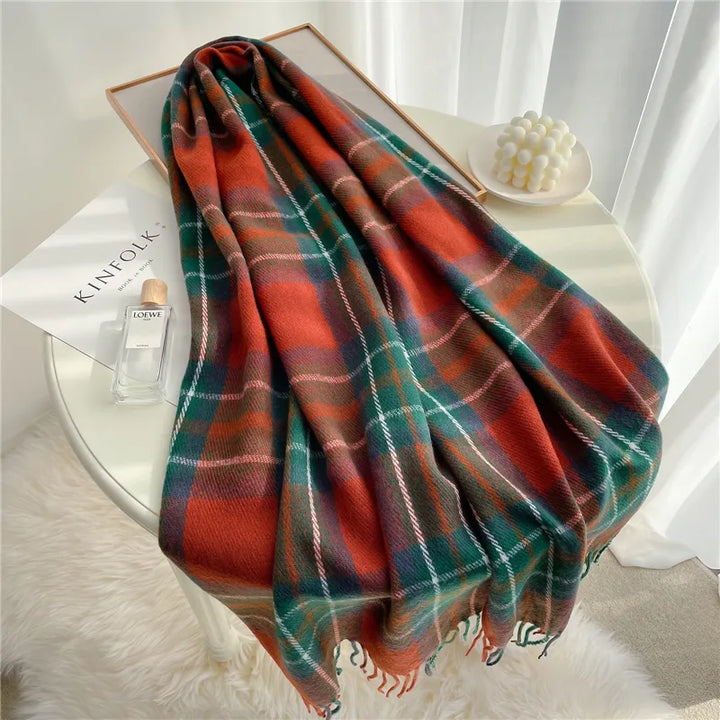 Fashionable women's knitted scarf in a classic checkered design, a warm winter accessory with tassels.