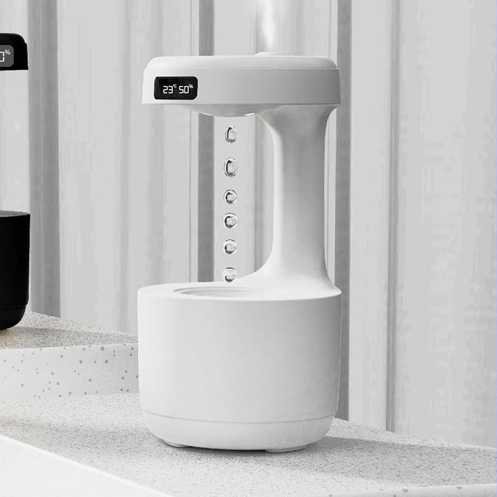Office desk anti-gravity humidifier with digital clock & LED light; boosts focus & air quality.
