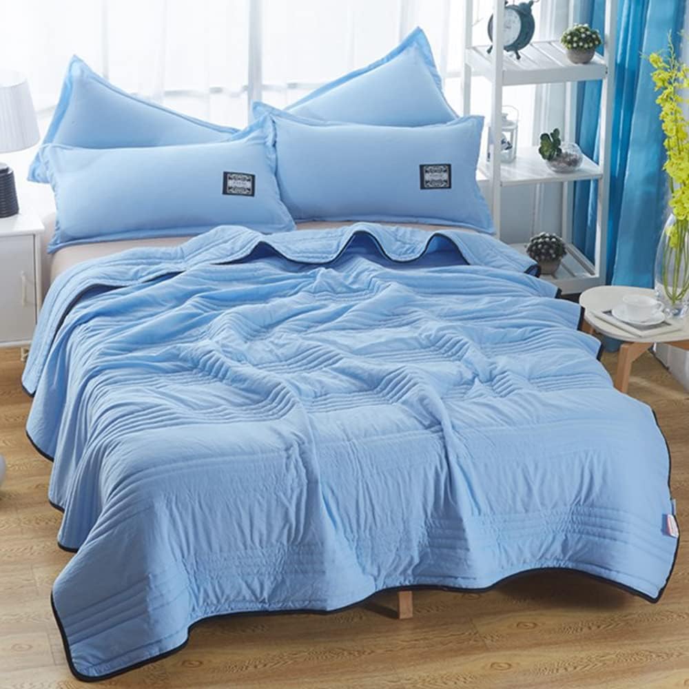 Breathable cooling throw blanket in gentle blue, providing cozy comfort as a stylish bed throw.