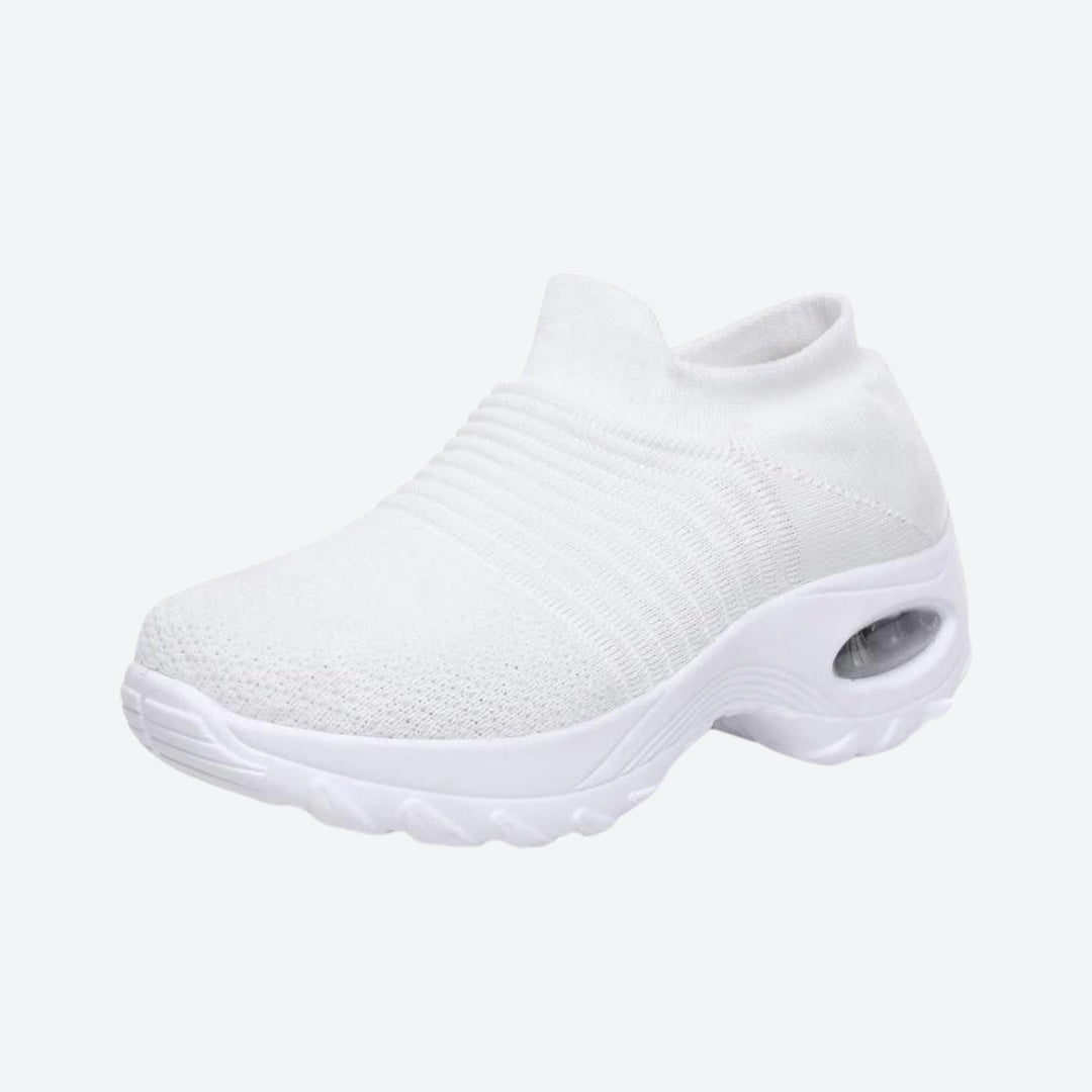 Comfortable White women's slip-on sneakers with arch support & air cushion for long walks.