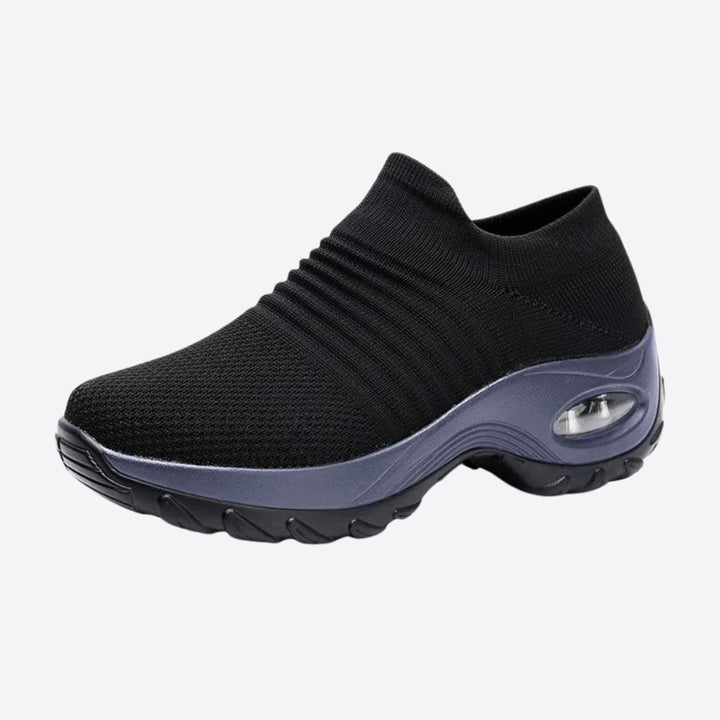 Women's Black arch support slip-on sneakers, ideal for all-day comfort & walking.