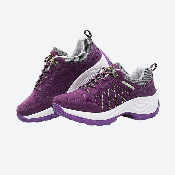 Purple women's athletic shoes with breathable upper & supportive arch technology.