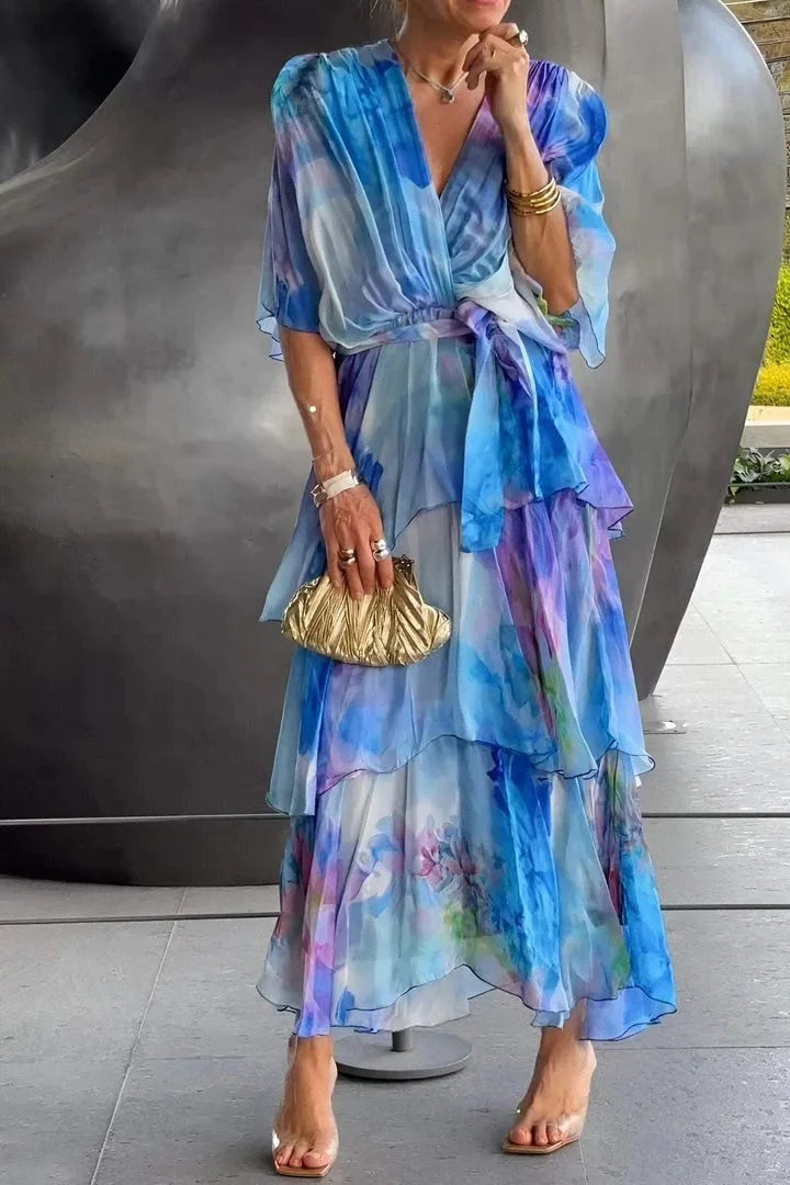 Flowing orange women's wrap maxi dress with elegant tiered ruffles, suitable for race day and sophisticated events.