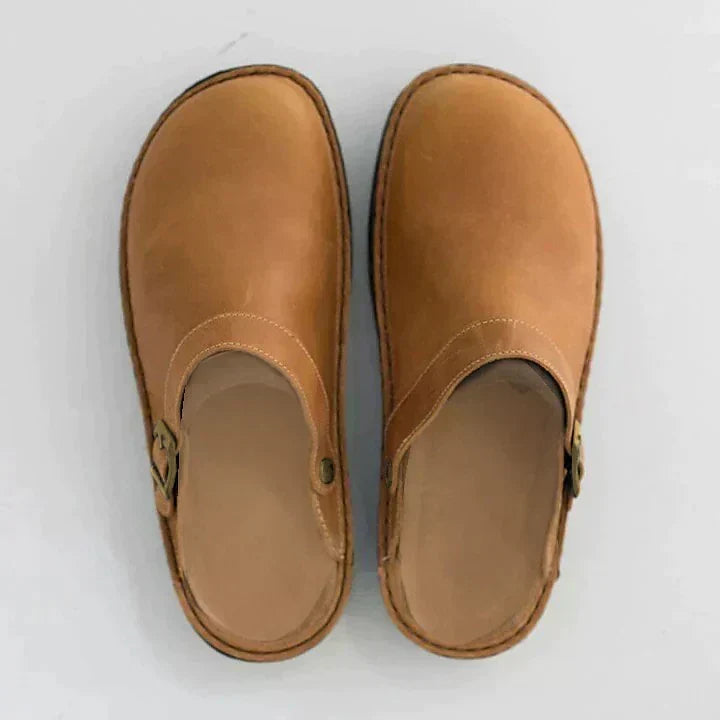 Black men's orthopedic slip-on clogs with adjustable buckle, providing essential foot support & all-day comfort.