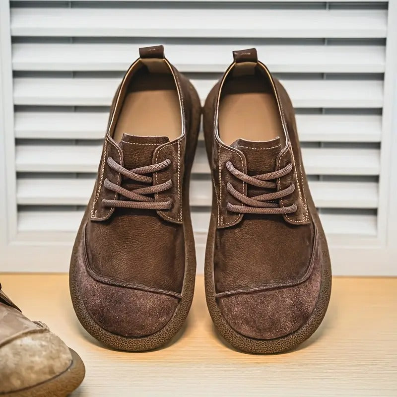 Angle shot of men's orthopedic walking shoes, highlighting robust construction & supportive arch for comfort.