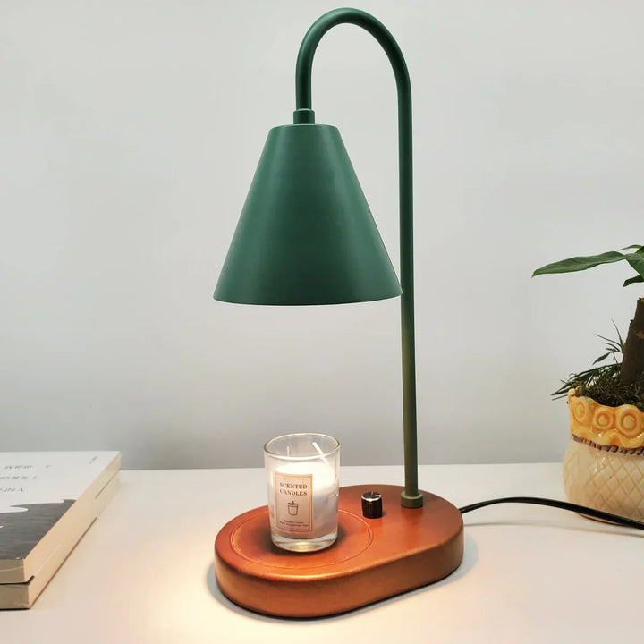 Metal electric candle warmer lamp with a sturdy wooden base, enhances bedside decor & provides soft, flameless light.