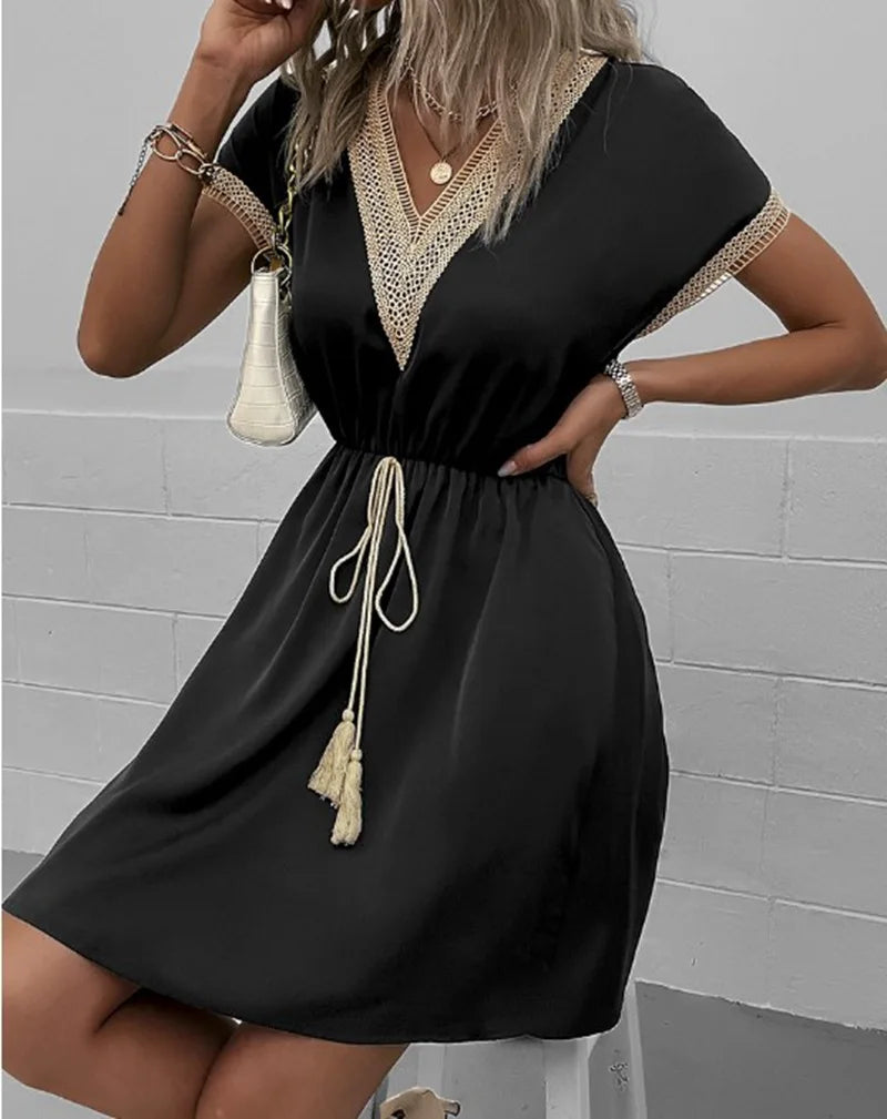 Lightweight women's vacation dress with elegant crochet details, flutter sleeves, and a comfy knee-length fit.