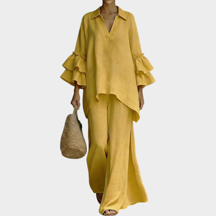 Comfortable women's flowy pants set with a stylish ruffle top & wide leg trousers, ideal for vacation wear.
