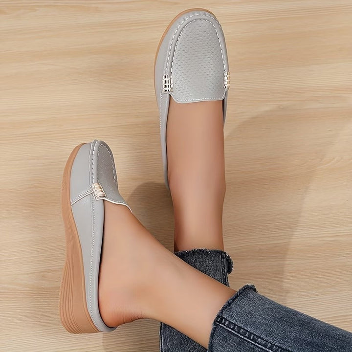 Stylish perforated women's slip-on wedge loafers, perfect for summer casual comfort.