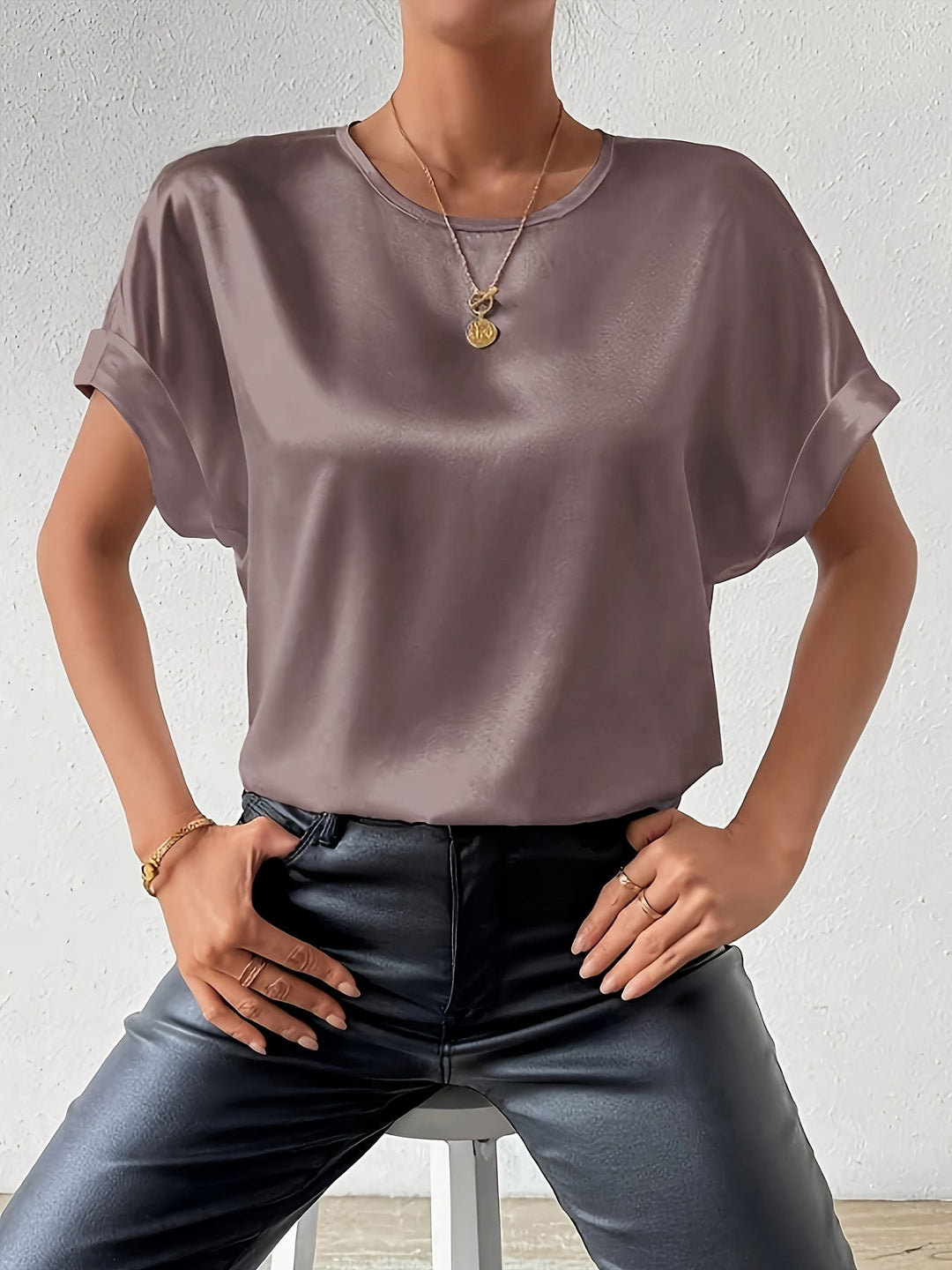 Woman in elegant short sleeve satin blouse, perfect for summer office or evening.