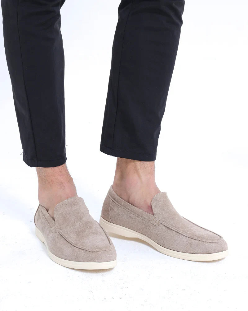 Comfortable men's beige slip-on shoes, blending casual moccasin style with a smart appeal for versatile wear.