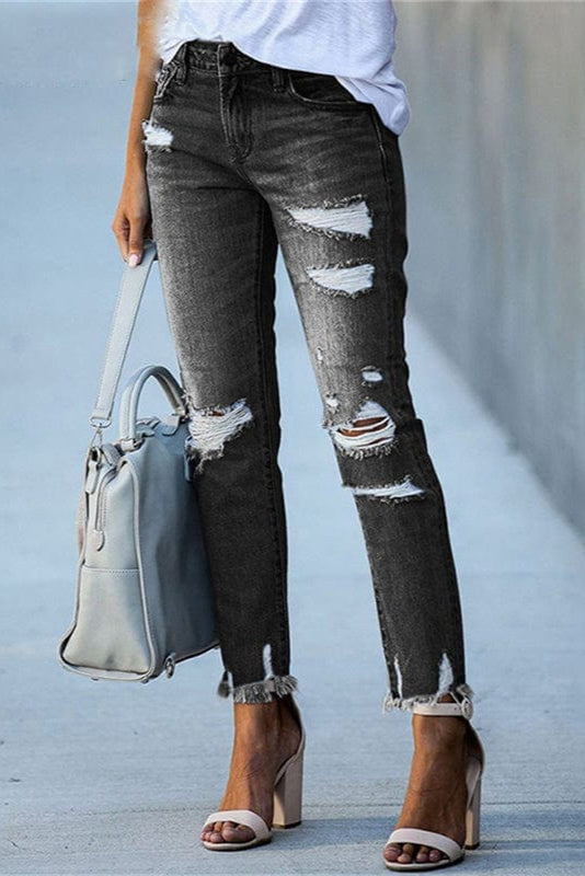 Women's mid-rise straight leg jeans, featuring chic distressing & a raw hem for an edgy, casual bottom.