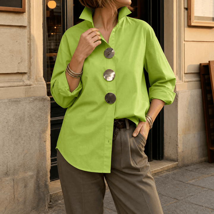 Women's collared oversized blouse, button-down, unique statement buttons for a fashion-forward style.