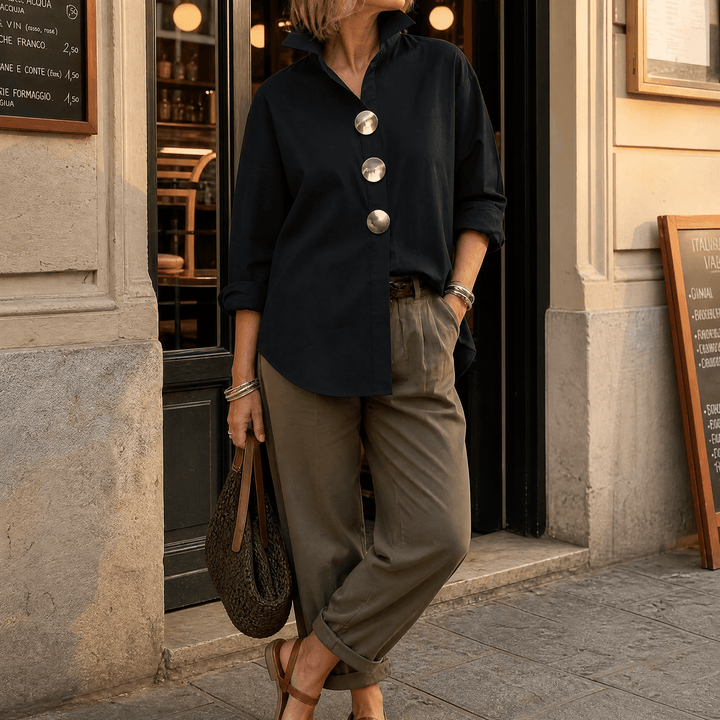 Relaxed yet chic women's oversized button-down blouse, prominent statement buttons, versatile top.