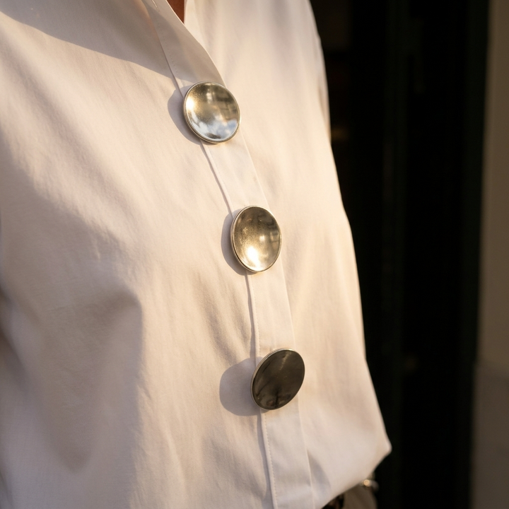 Fashionable women's collared button-down top, oversized fit, statement buttons, a versatile piece.