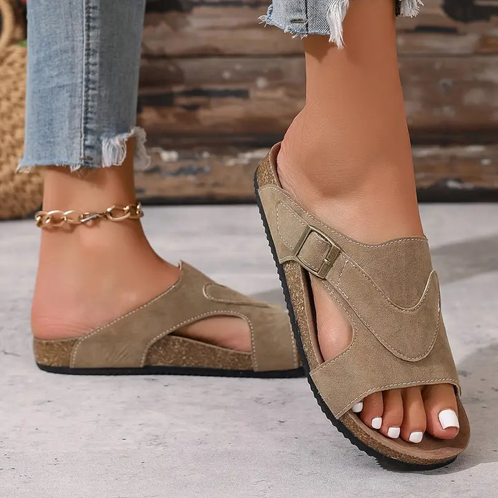 Open-toe Brindelle flat sandals with an ankle buckle strap, great for women's summer comfort.