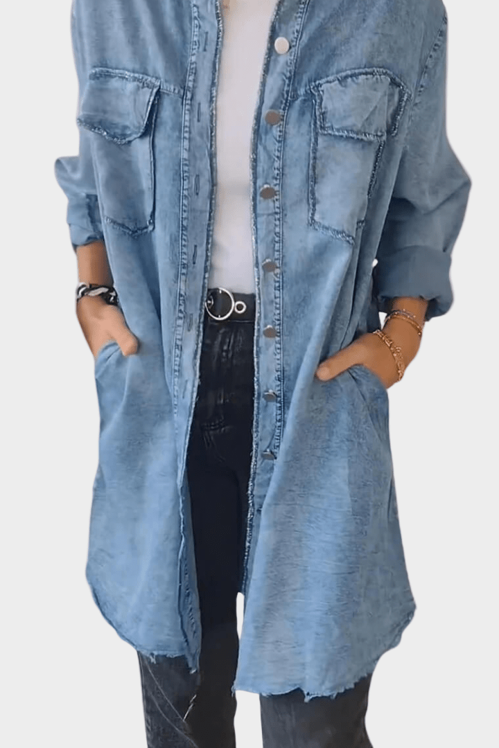 Close-up of a women's oversized shirt mini dress featuring a stylish raw hem & button-front detail.