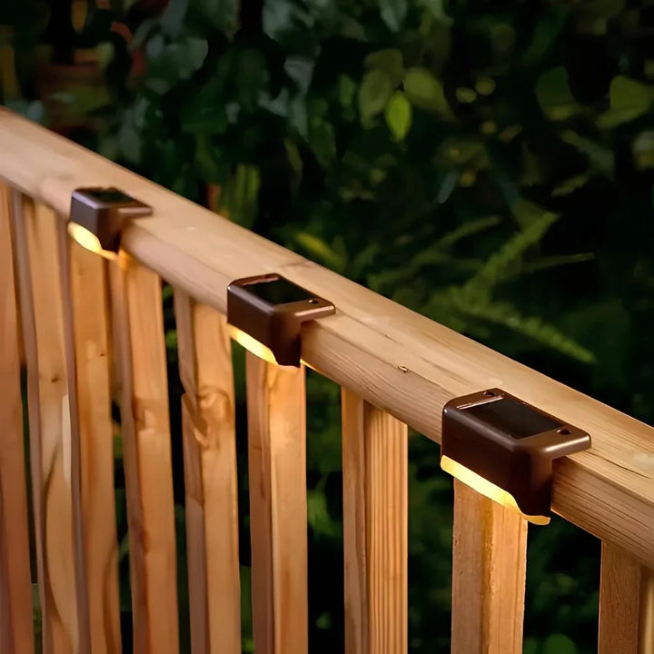 Warm glow Nvroome solar step lights lighting up a backyard walkway, enhancing garden ambiance.
