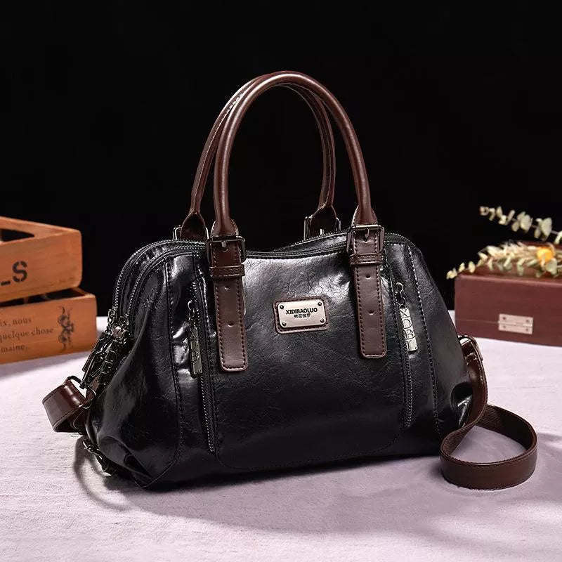 Women's versatile black leather shoulder bag. Durable genuine leather handbag, ideal for everyday fashion.