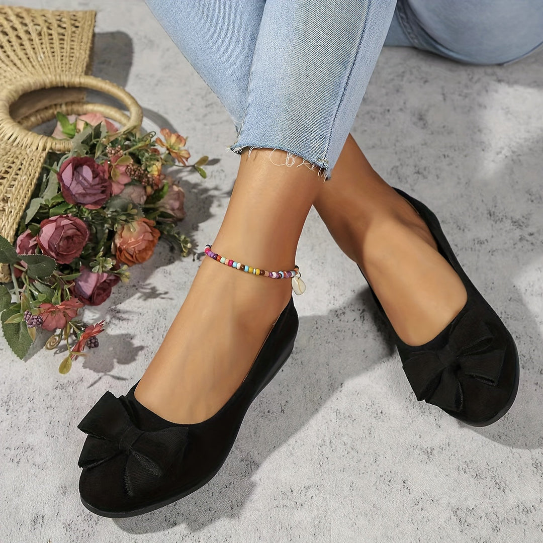 Vibrant red ladies' wedge ballet flats, comfortable slip-on footwear with a standout bow detail.