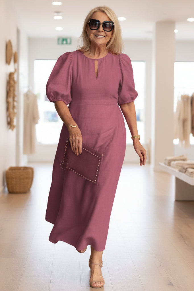 Fashionable women's summer dress, a midi length with short puff sleeves, ensuring tummy coverage and style.