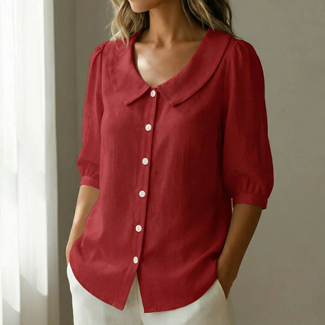 Women's chic blouse with Peter Pan collar, puff sleeves & button-up front.