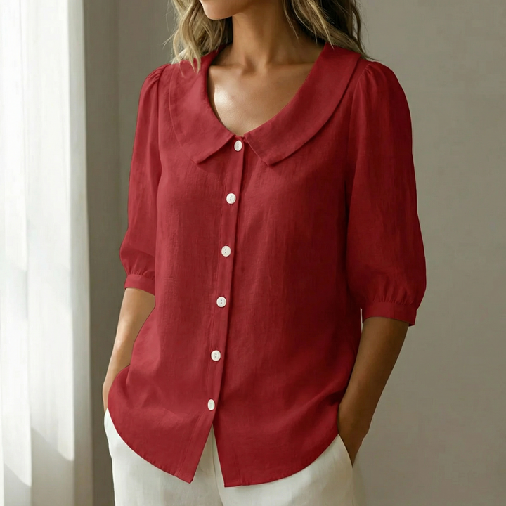 Women's chic blouse with Peter Pan collar, puff sleeves & button-up front.