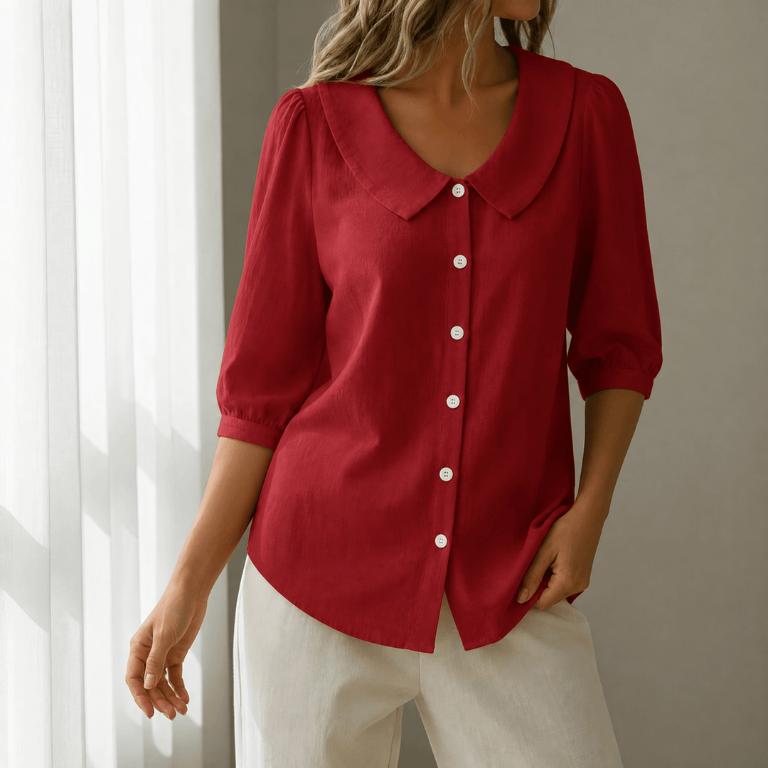 Modern women's workwear top, featuring a stylish Peter Pan collar for office.