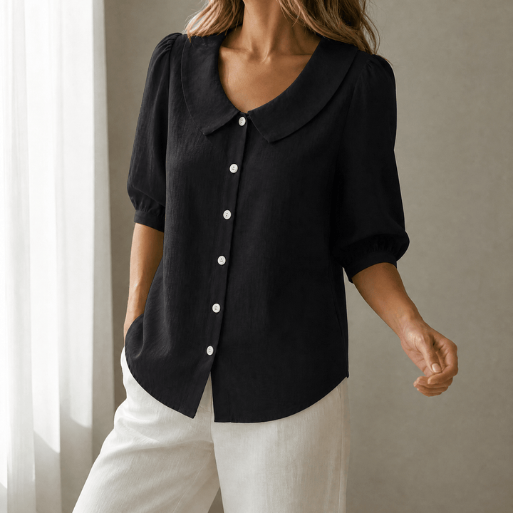 Women's fashionable button-up blouse, highlighting a cute Peter Pan collar.