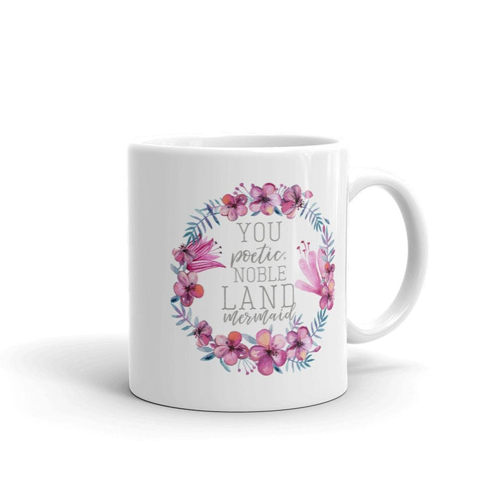 Unisex white ceramic coffee mug, ideal gift, featuring an elegant floral wreath and motivational quote.