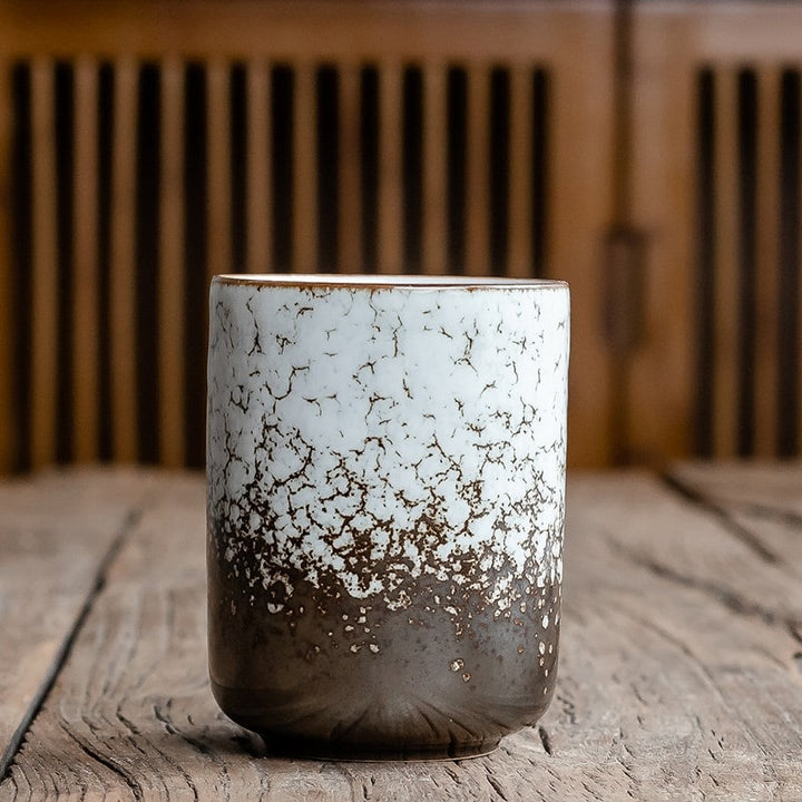 Japanese handleless ceramic teacup with elegant crackle glaze texture, perfect for traditional tea ceremonies.