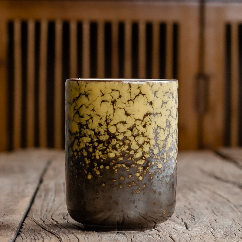 Handcrafted handleless ceramic teacup with a stunning crackle glaze, showcasing artisan Japanese quality.