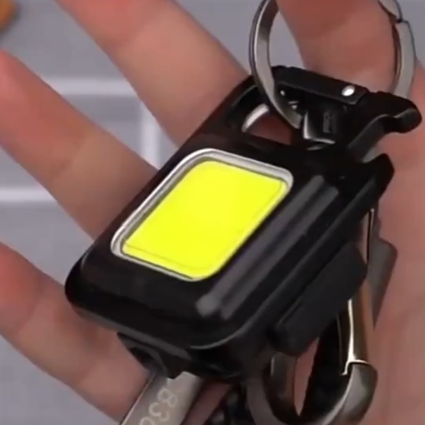 Multi-tool keychain flashlight: rechargeable LED & COB light, bottle opener. Essential portable EDC gadget.
