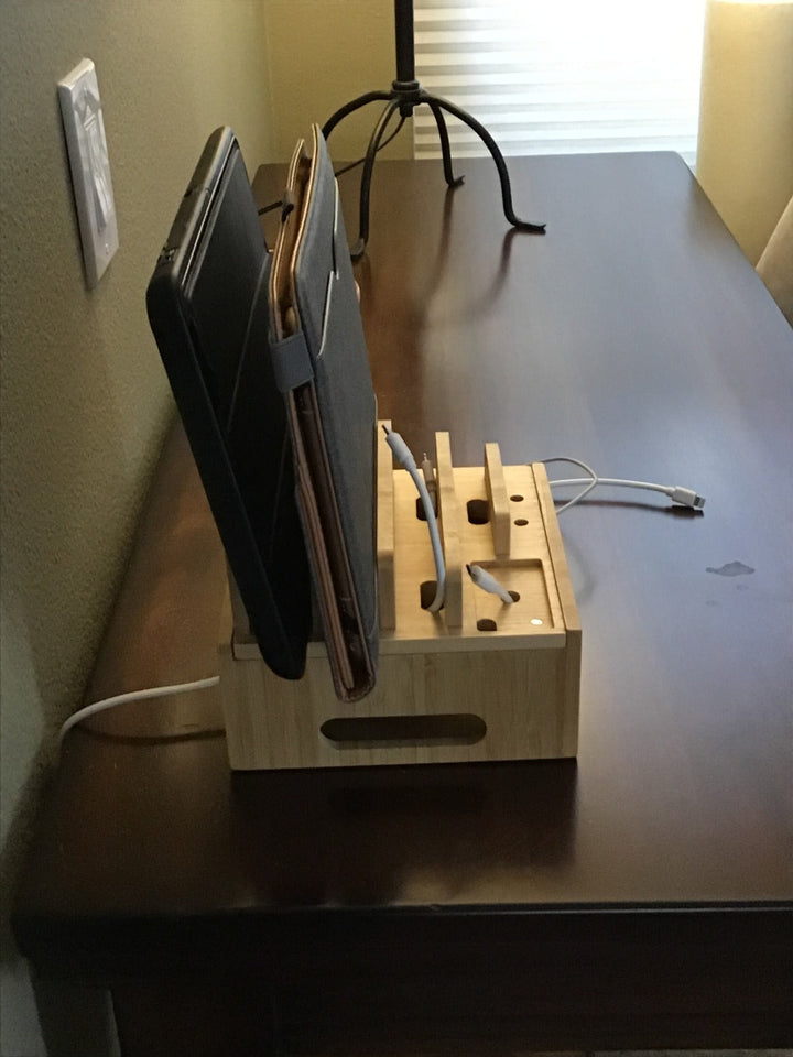 Natural bamboo charging station organizes smartphones, tablets, & smartwatches with 5 USB ports for quick power.